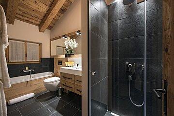 A bathroom with a toilet a sink and a shower