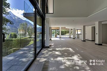 An empty room with a knight frank logo on the bottom