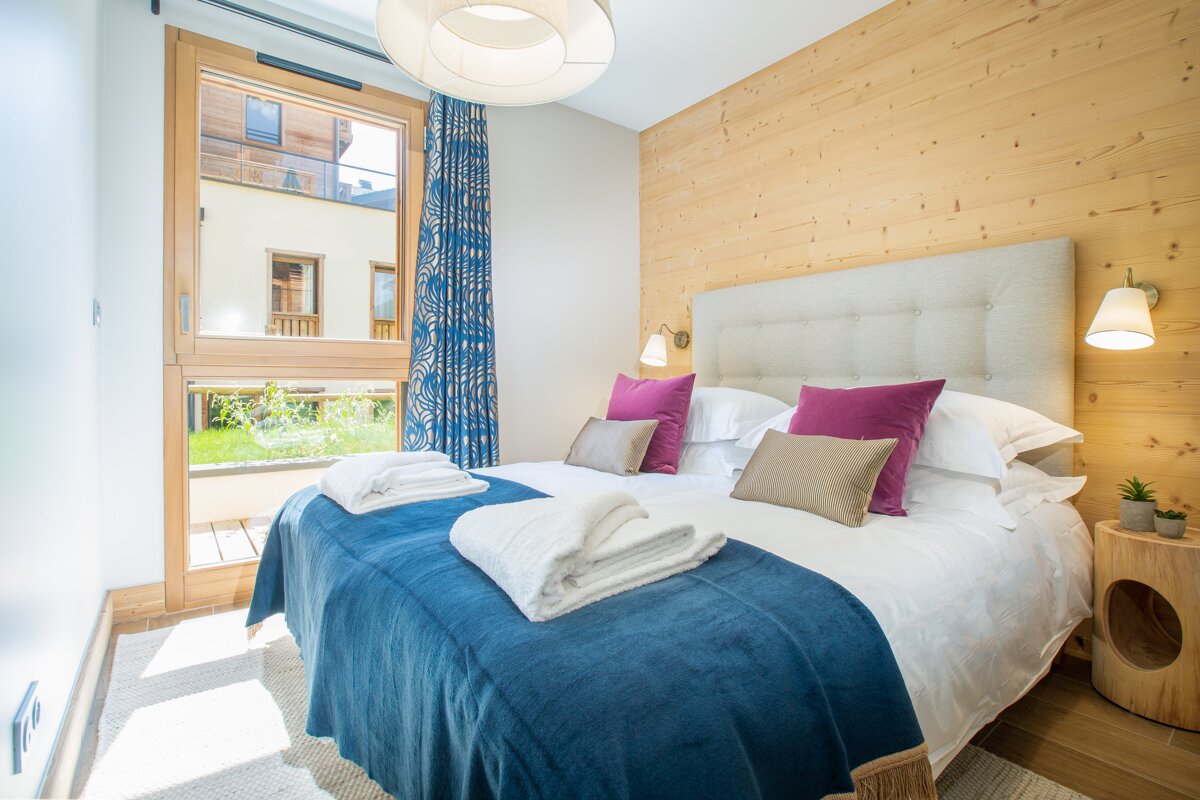 A bedroom with a large bed and a window