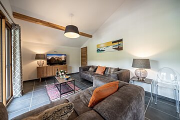 A living room with two couches and a flat screen tv