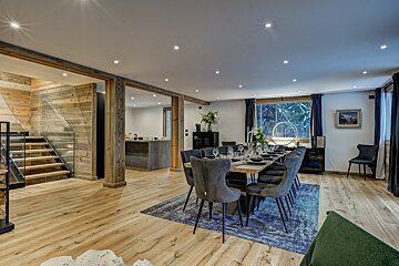 A dining room with a long table and chairs