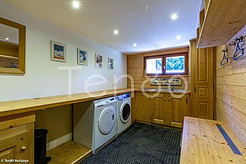 A laundry room with a washer and dryer and a sign that says ten80 holidays
