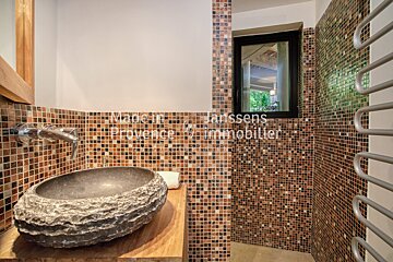 A bathroom with a sink and a sign that says made in provence