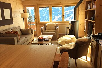 A living room with a couch a chair a table and a fireplace
