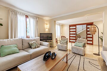 A living room with a couch and two chairs