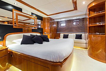 A bedroom with a large bed and a couch