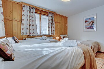 A bedroom with two beds and a poster on the wall that says