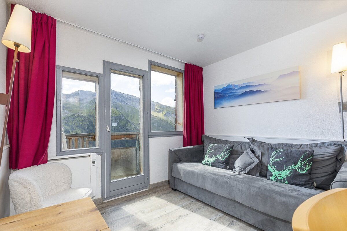 A living room with a couch and a painting on the wall
