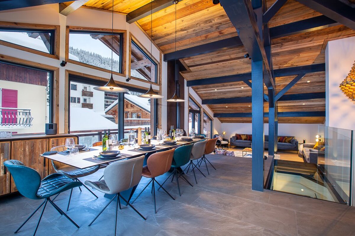 A dining room with a large table and chairs
