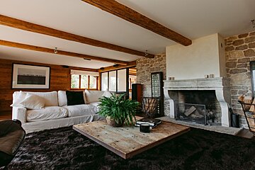 A living room with a white couch and a fireplace