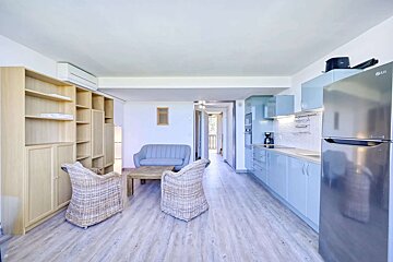 An lg refrigerator sits in the middle of a living room
