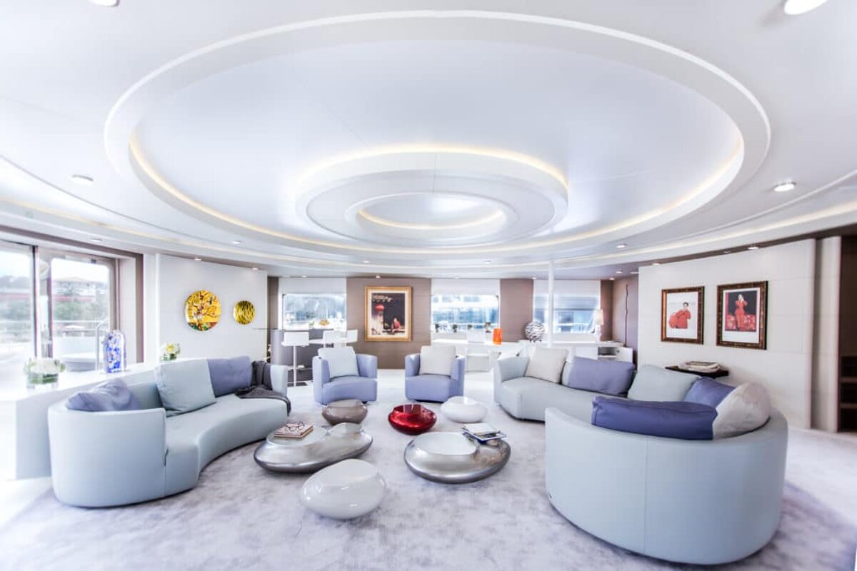 A living room with white furniture and a circular ceiling