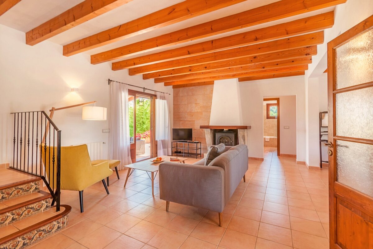 A living room with a couch and chairs and a fireplace