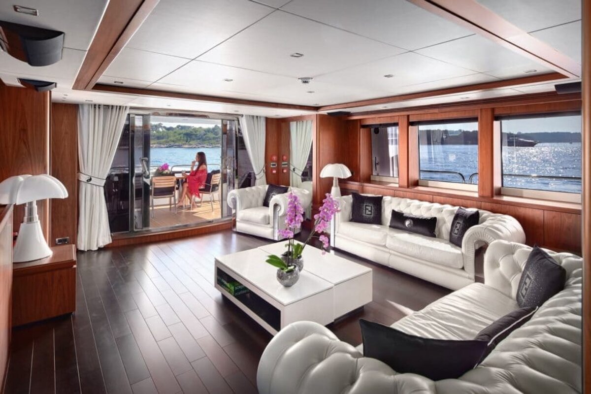 A woman sits at a table on a boat in a living room