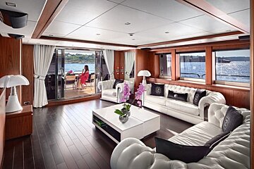 A woman sits at a table on a boat in a living room