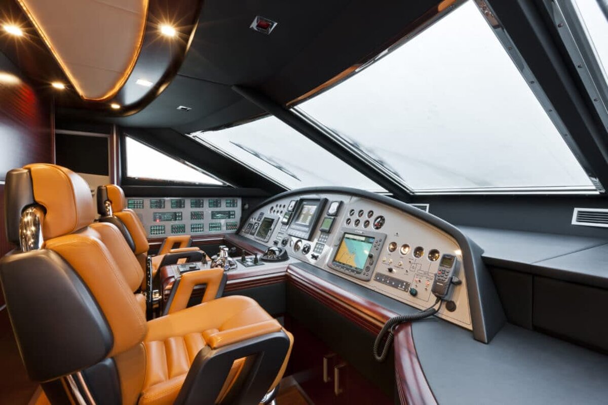 A cockpit of a boat with a gps on the dashboard