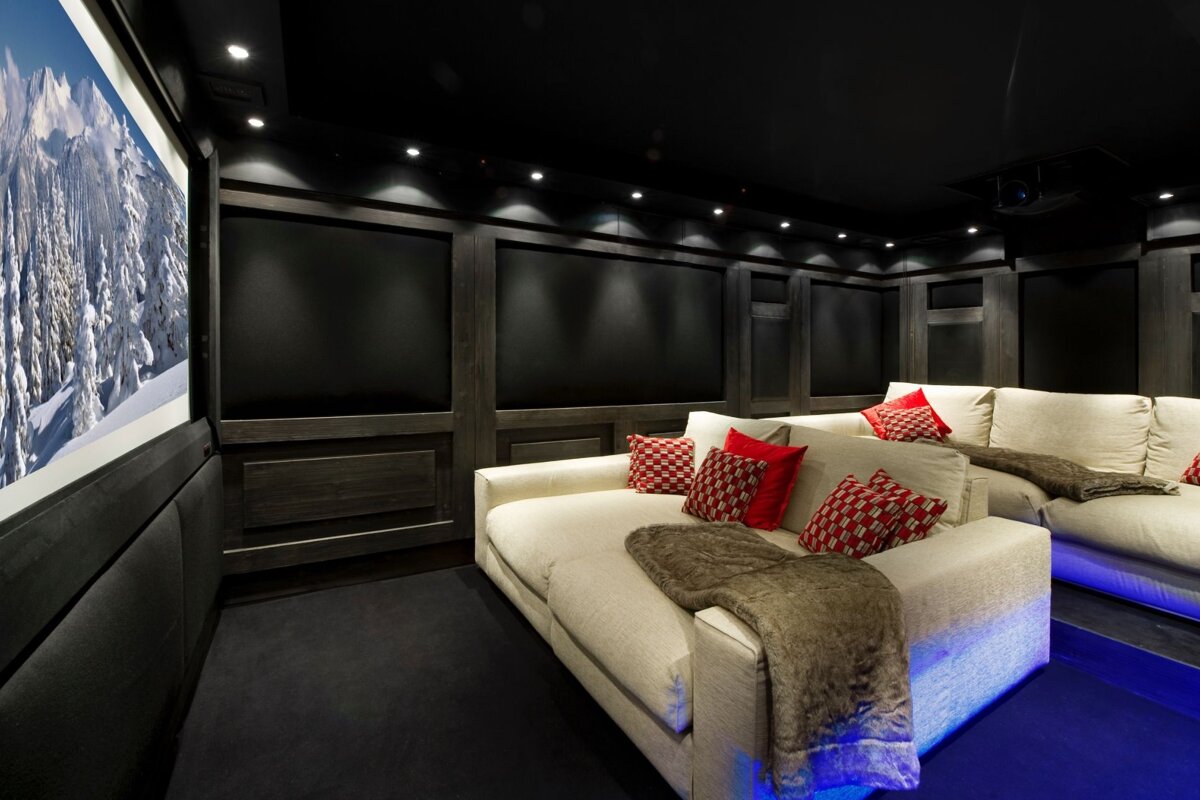 A home theater with a picture of mountains on the wall