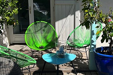 A green chair sits next to a blue table
