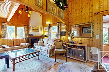 A living room with a couch a chair a coffee table and a mirror