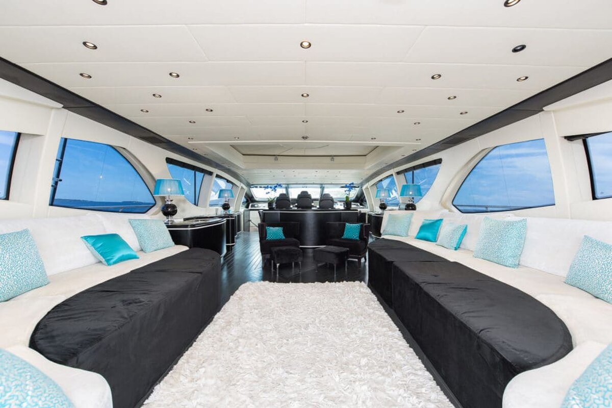 The inside of a boat with a couch and a rug