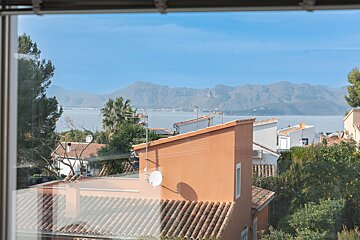 A view of a house with mountains in the background