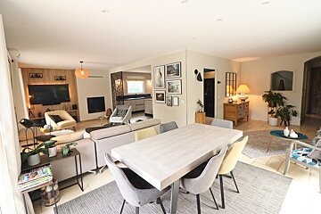 A living room with a dining table and chairs