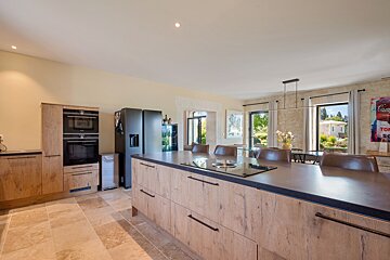 A kitchen with a painting on the wall that says campbell 's