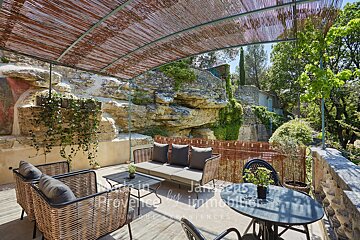A balcony with a couch and chairs and the words made in provence by immobilier