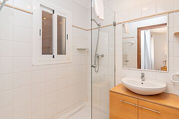 A bathroom with a sink and a walk in shower