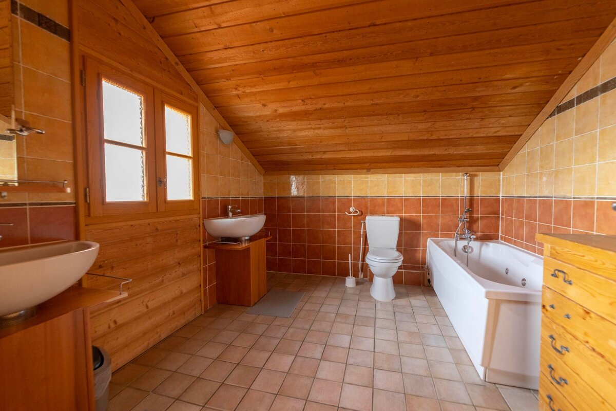 A bathroom with a toilet a sink and a bathtub
