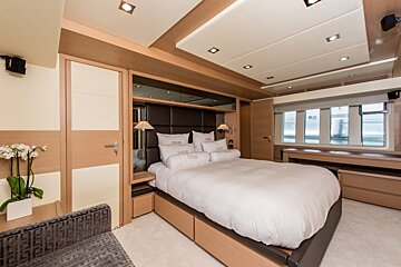 A bedroom with a bed and pillows that say ' tdm ' on them