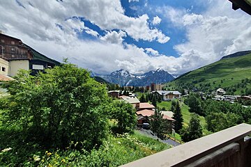 A view of a valley with mountains in the background