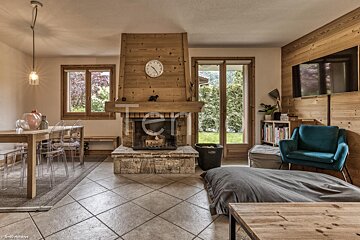 A living room with a fireplace and a clock that says ten on it