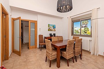 A dining room with wicker chairs and a table