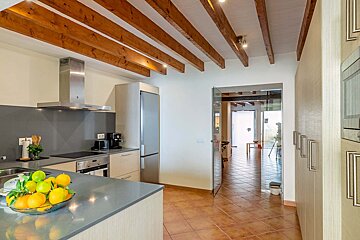 A kitchen with a bowl of lemons on the counter
