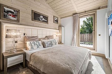 A bedroom with a large bed and a window
