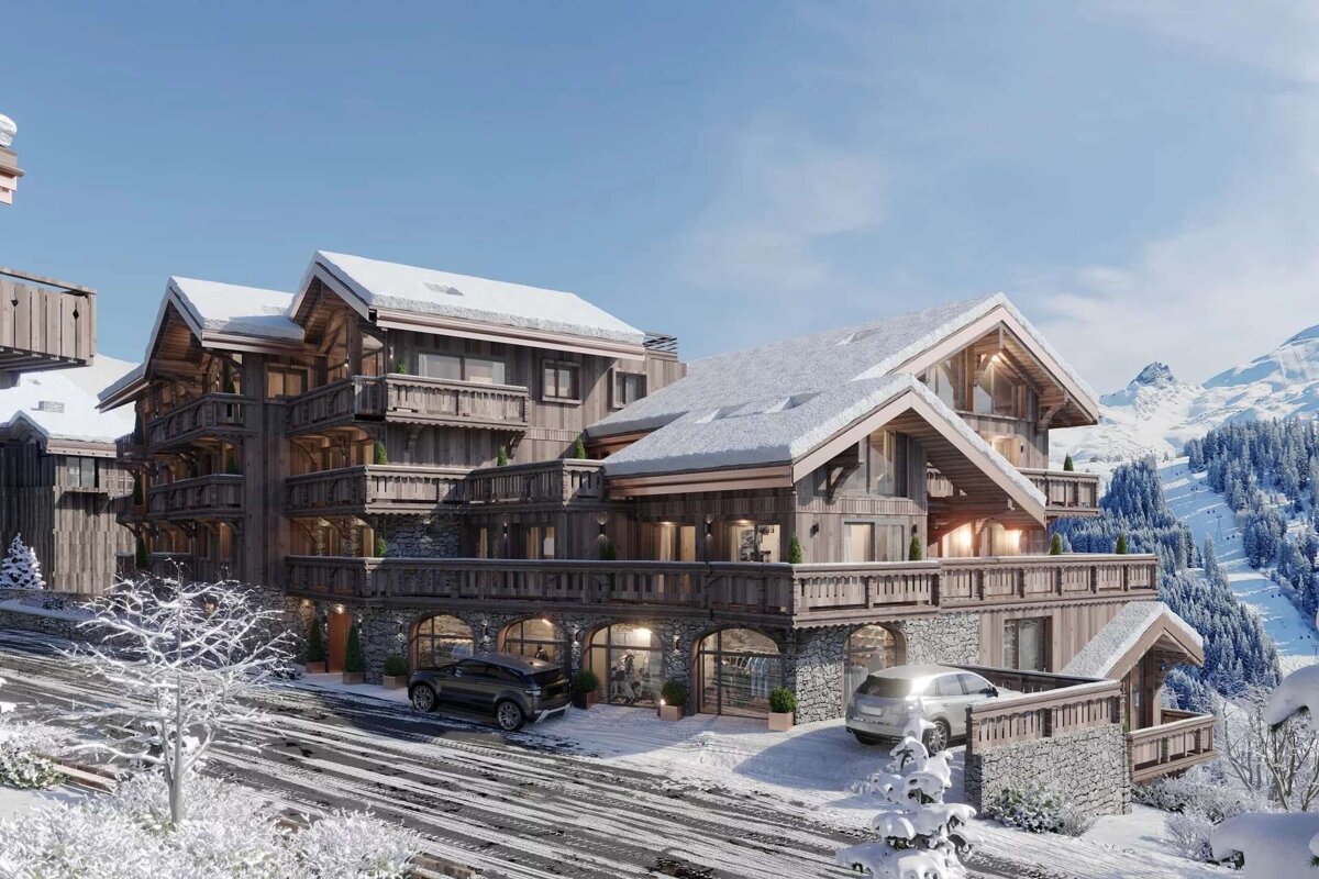 Luxurious wooden chalets with snow-covered roofs in a stunning mountain ski resort setting. Cars are parked on the snowy road.