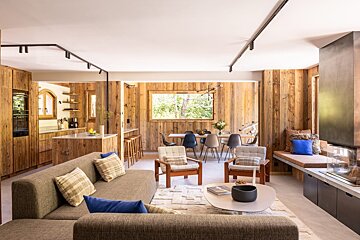 A living room with a couch and chairs in it