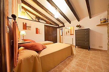 A bedroom with two beds and a dresser