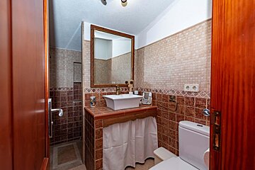 A bathroom with a toilet a sink and a mirror