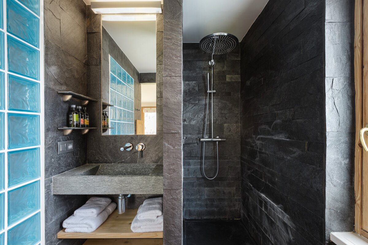 A bathroom with a sink and a walk in shower