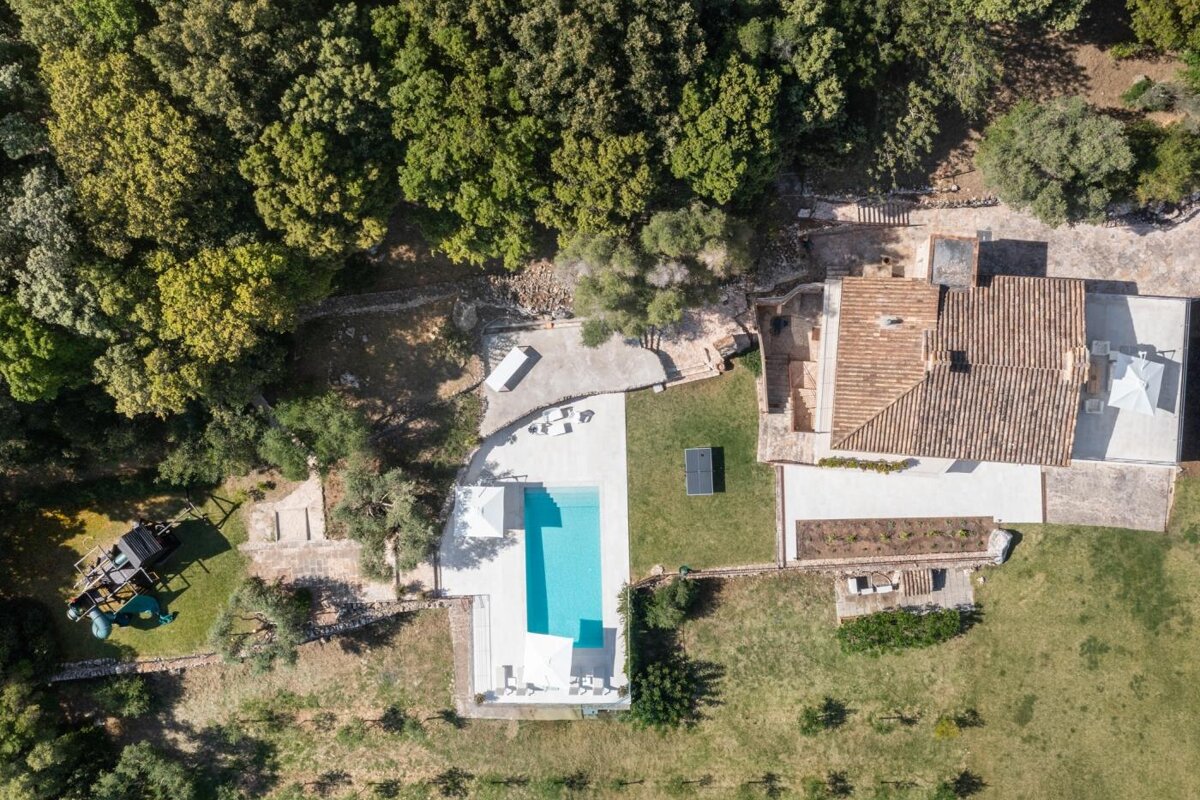 An aerial view of a house with a swimming pool