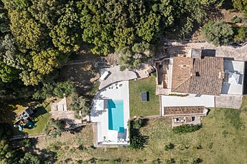 An aerial view of a house with a swimming pool