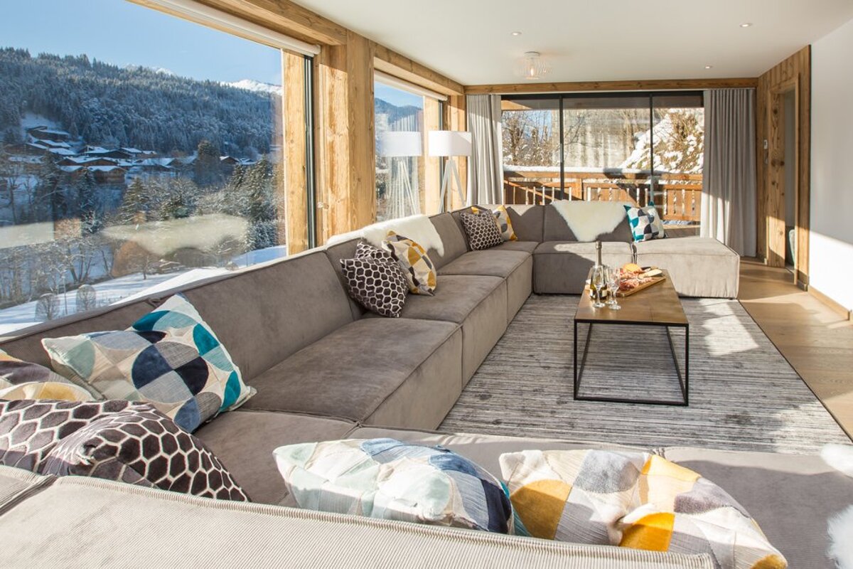 A living room with a large sectional couch and a coffee table