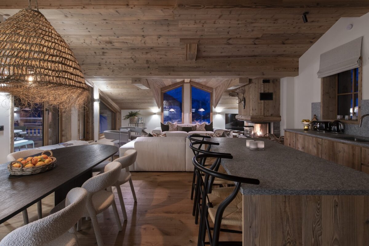 A living room with a dining table and chairs