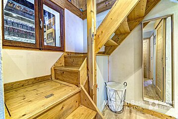 A wooden staircase leading up to the second floor of a house