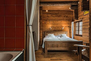 A bedroom with a wooden bed and a sign that says ' l' eau ' on it