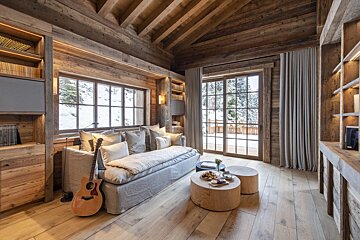 A living room with a couch and a guitar