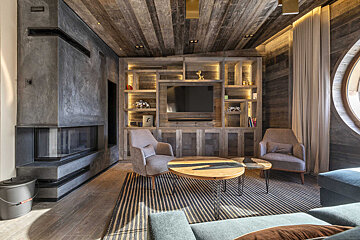 A living room with a fireplace and a flat screen tv
