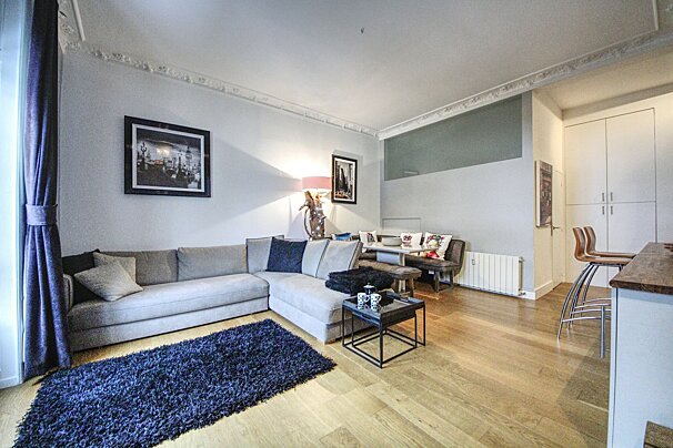 A living room with a couch and a rug